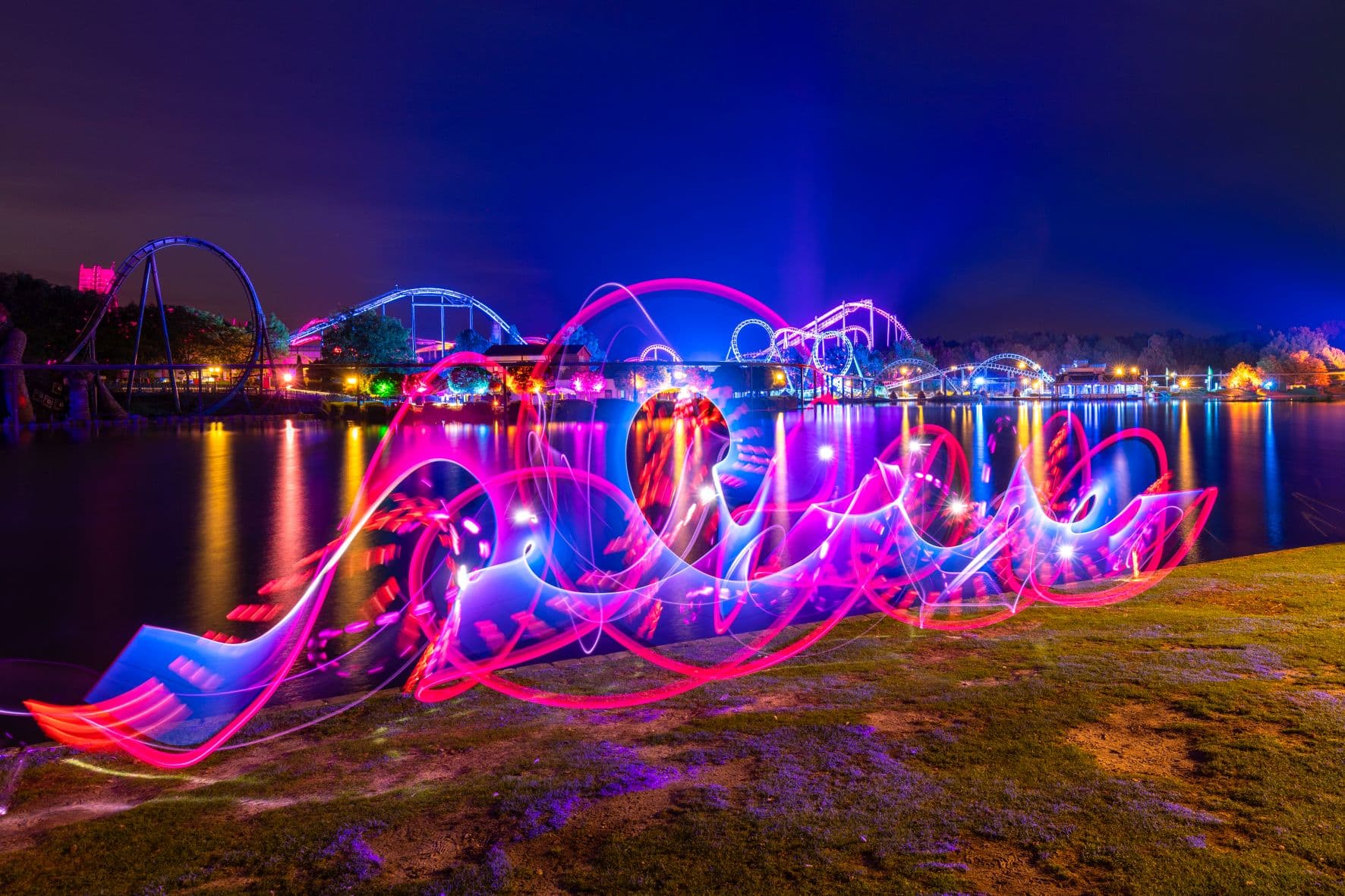 karussels und fahrgeschäfte sind im Dunkeln beleuchtet